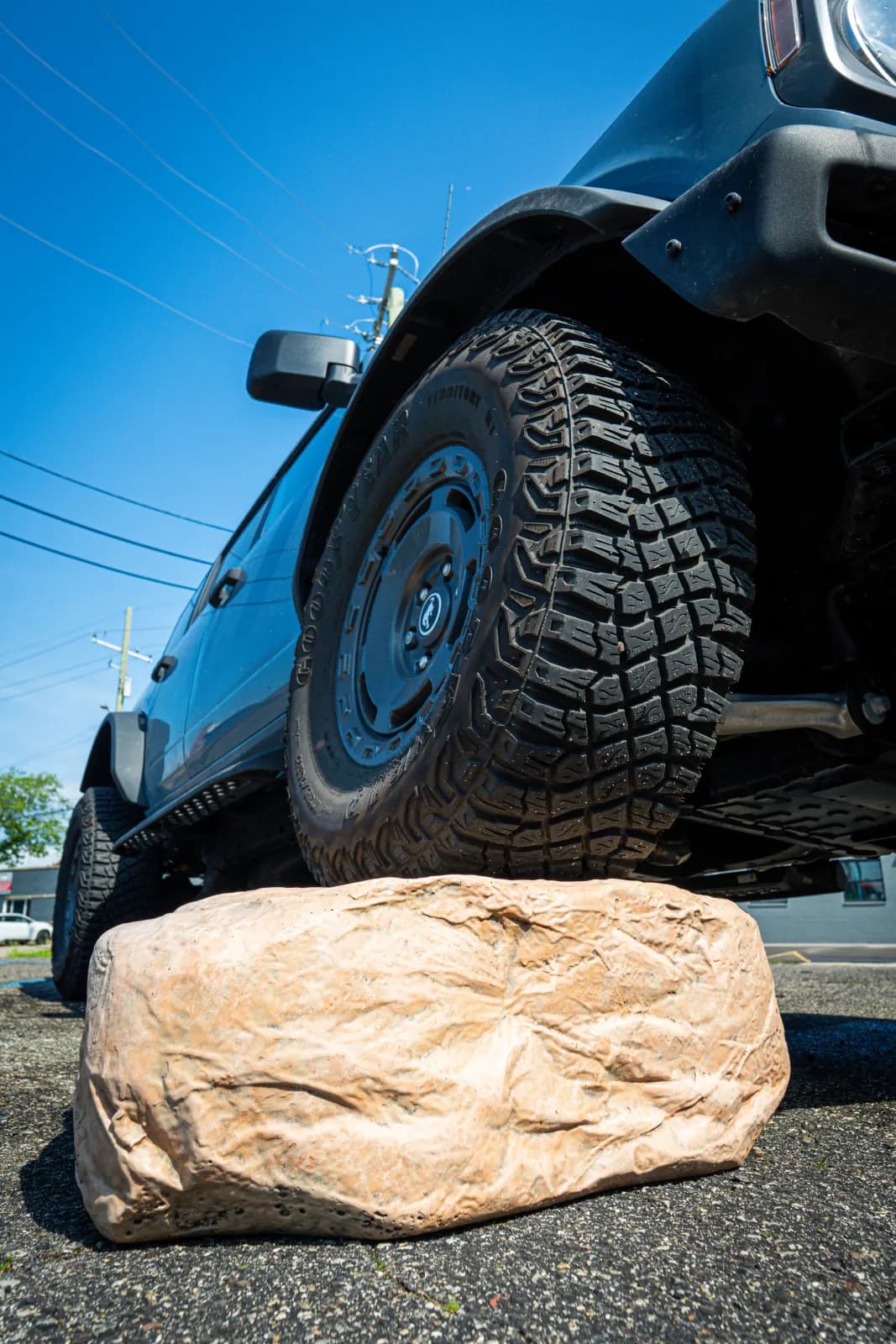 The Boulder Buddy under a Ford Bronco's front tire