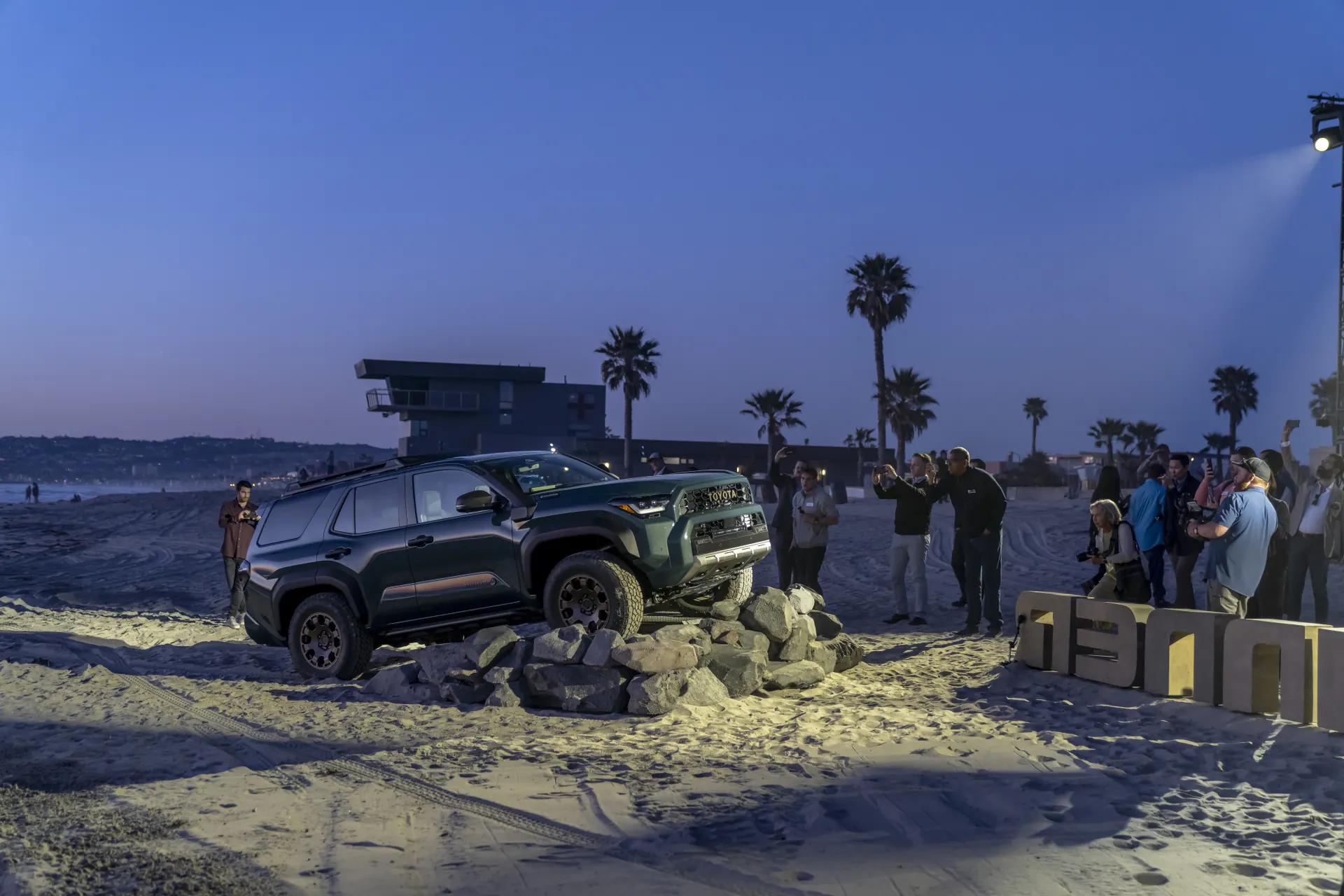 Crowd photographing a 4Runner Trailhunter on the Rock Ramp at dusk